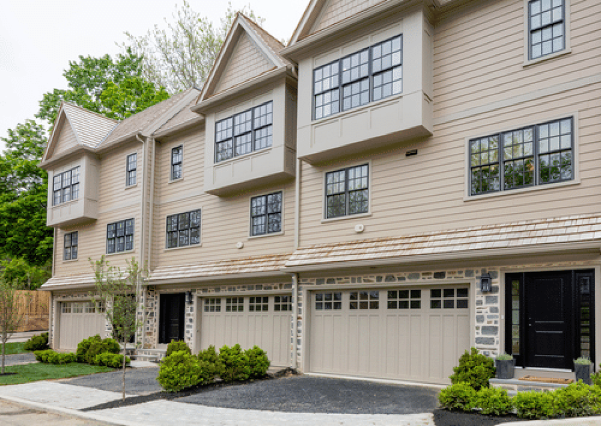 a large tan building with a driveway and trees in Norristown PA