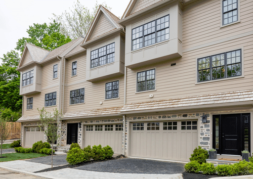 a large tan building with a driveway and trees in Norristown PA